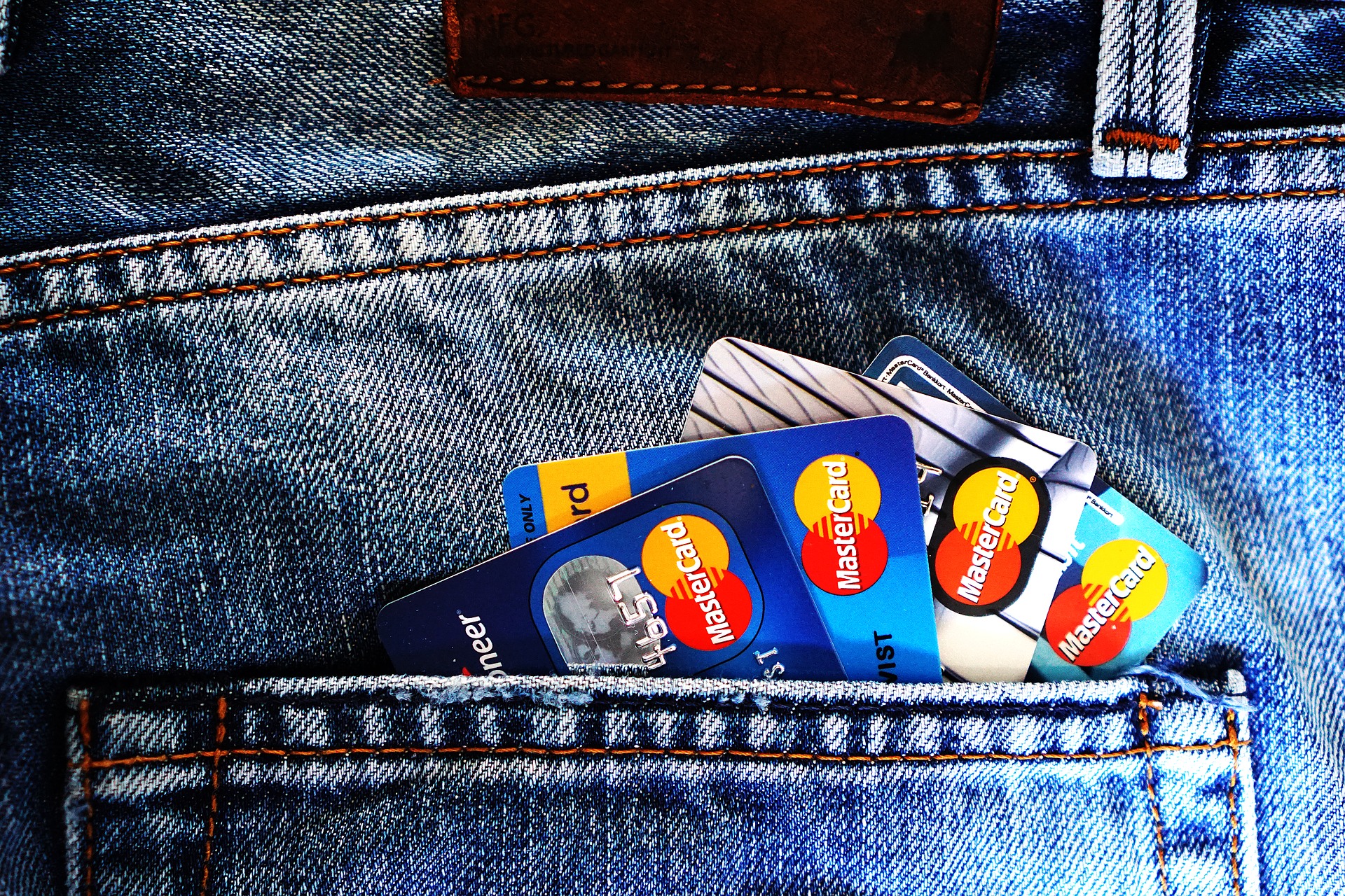 Denim jean pocket holding four credit cards