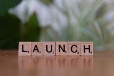 Scrabble tiles spelling 'launch'.
